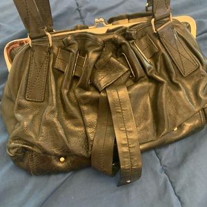 Black shoulder purse with old fashioned clasp and side pockets